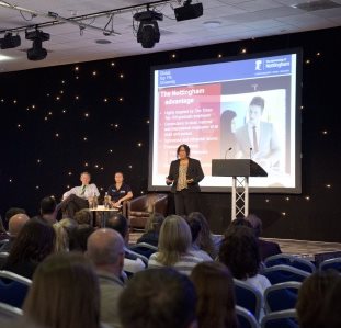 A group of people listening to a conference speech